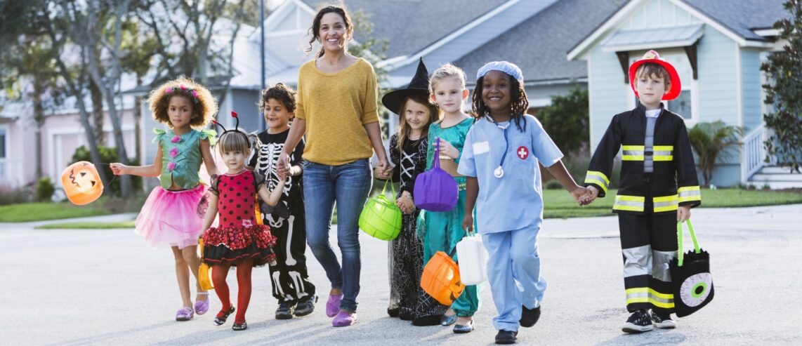 Reflective clothing and adult supervision help keep children visible and safe while trick-or-treating.