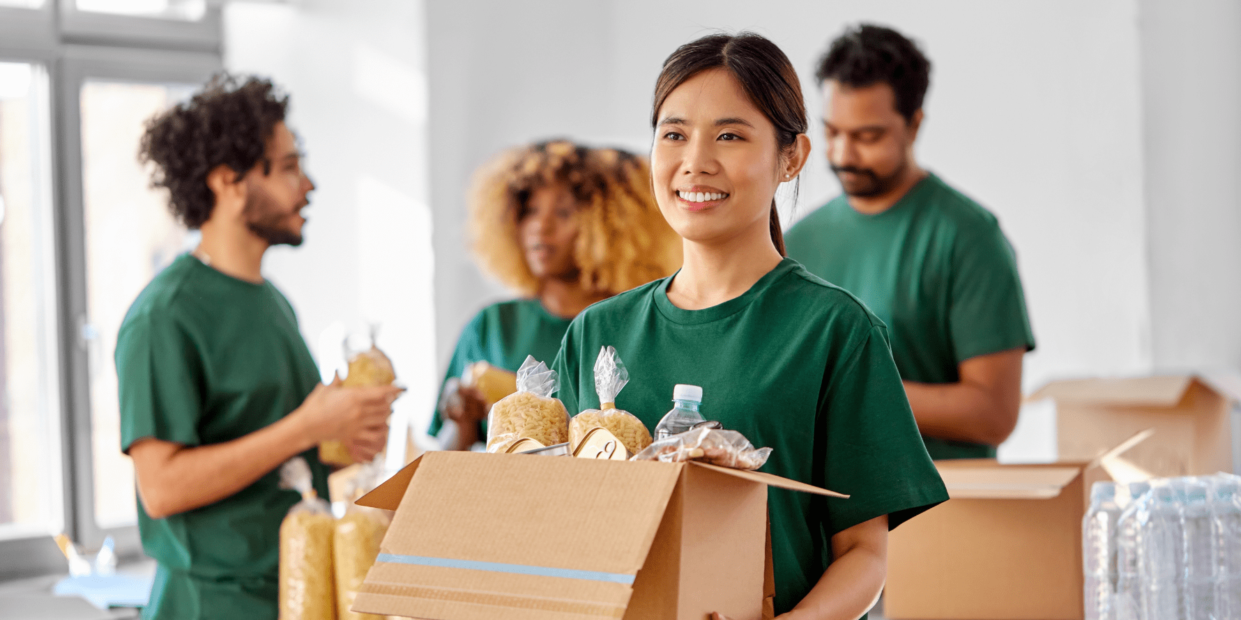 Volunteers pack boxes of groceries for distribution at area food pantries.